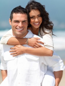 Happy young couple having fun on the beach